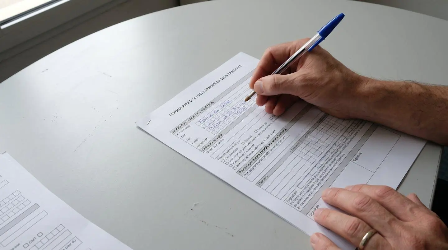 Gros plan sur un formulaire administratif posé sur un bureau avec un stylo, éclairage naturel doux, environnement de travail réaliste